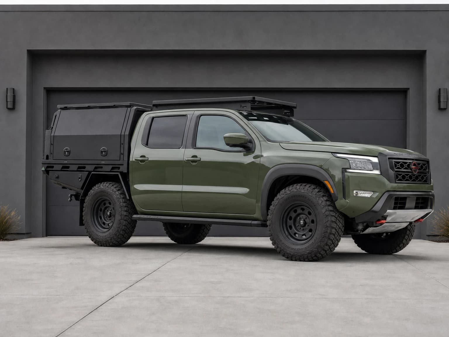 Green Nissan Frontier visual concept with touring canopy, roof rack, steel wheels, mud-terrain tyres and running boards